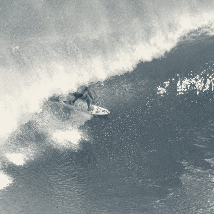 Ryan Ragan setting his rail on a glassy overhead emerald wave face