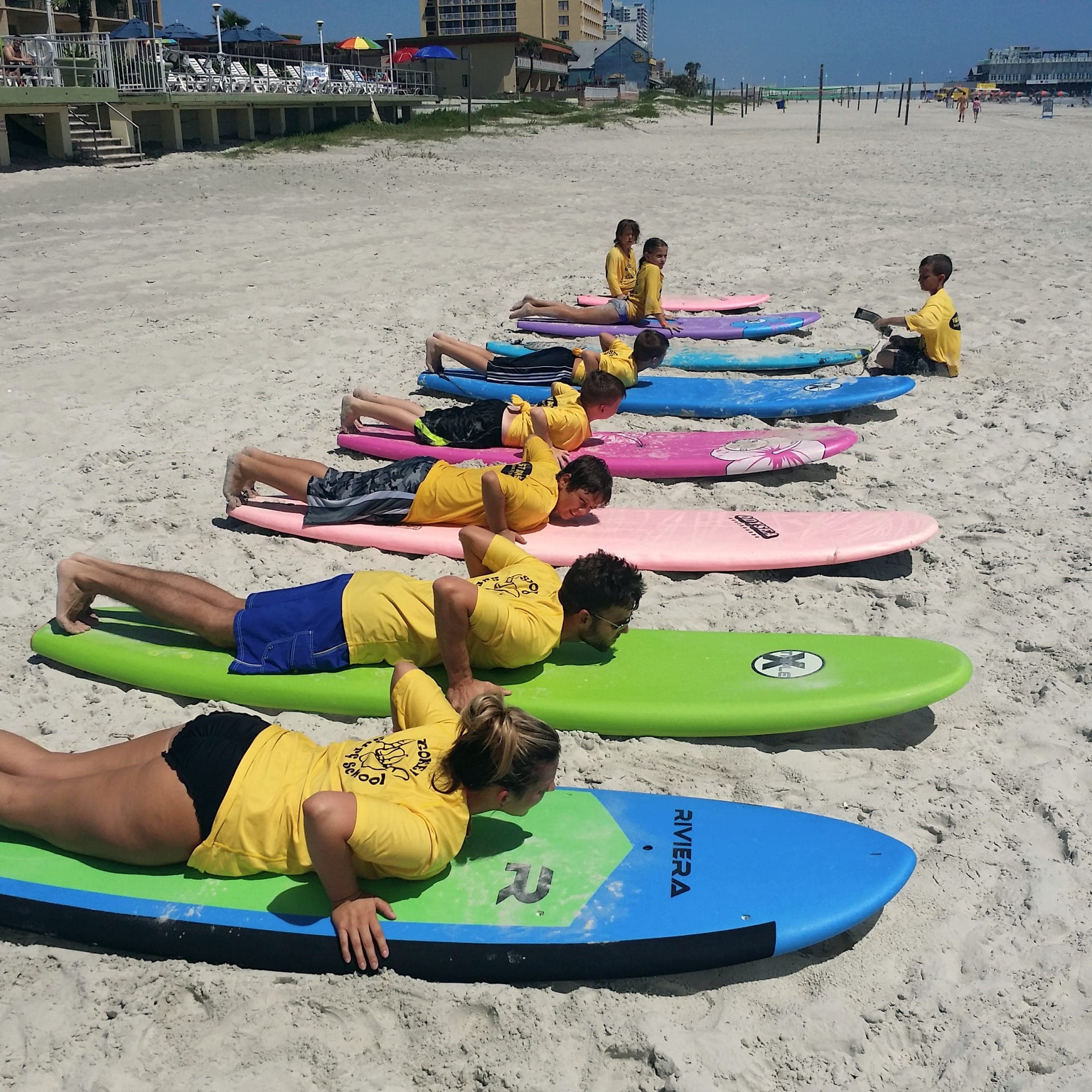 Paddle drill line on the sand on a sunny lesson morning