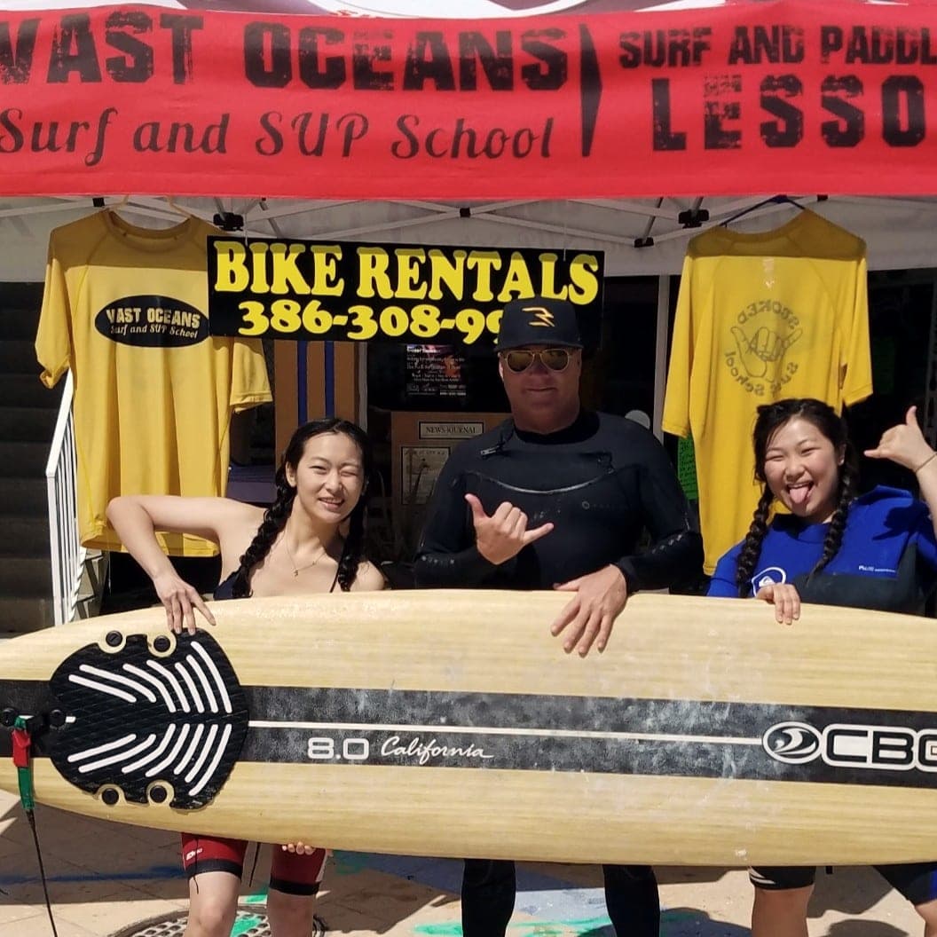 Two students with Ryan at the branded Vast Oceans lesson tent