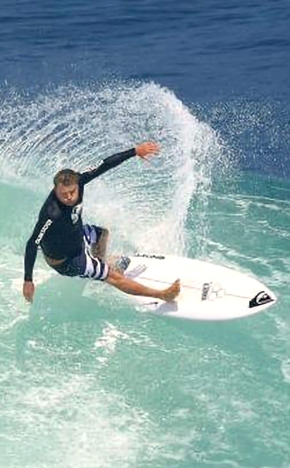 Ryan Ragan hitting the lip of a clean wave with his arm extended