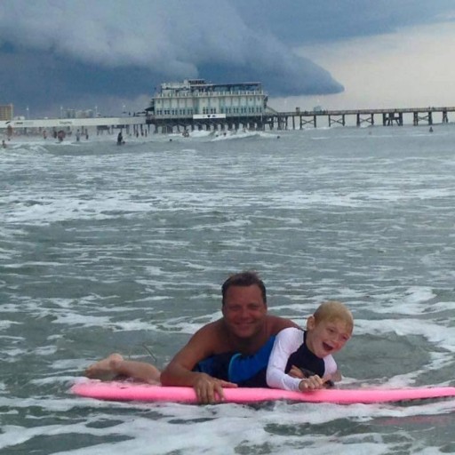 Ryan helping a Young Student Paddle Out